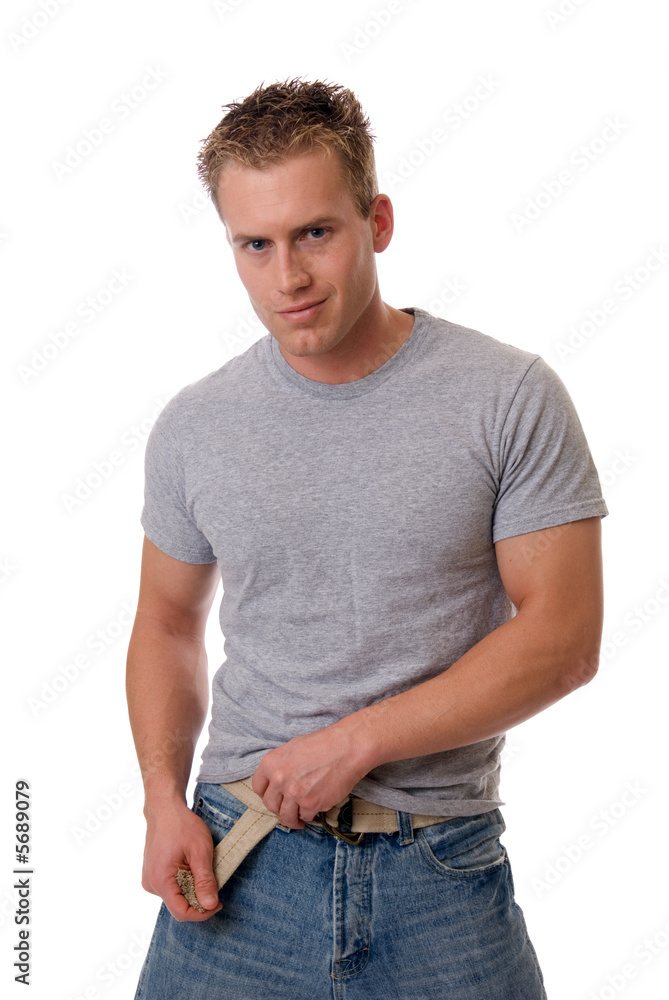 A handsome muscular man tugging on his belt