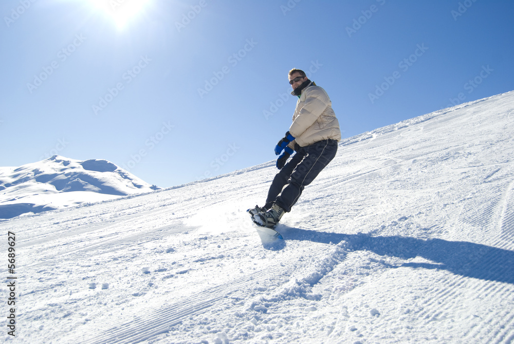 Snowboarding in a bright sunny day stock photo