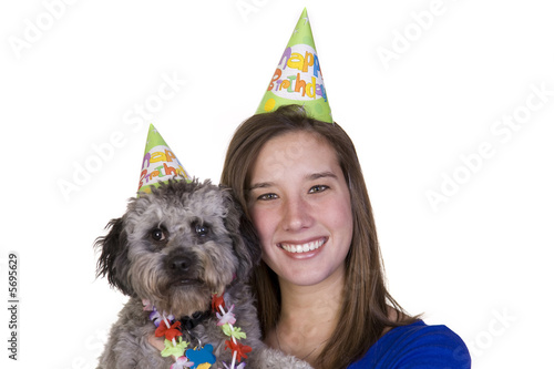 Girl and her dog in their birthday hats