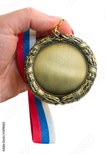 gold medal in hand isolated over white