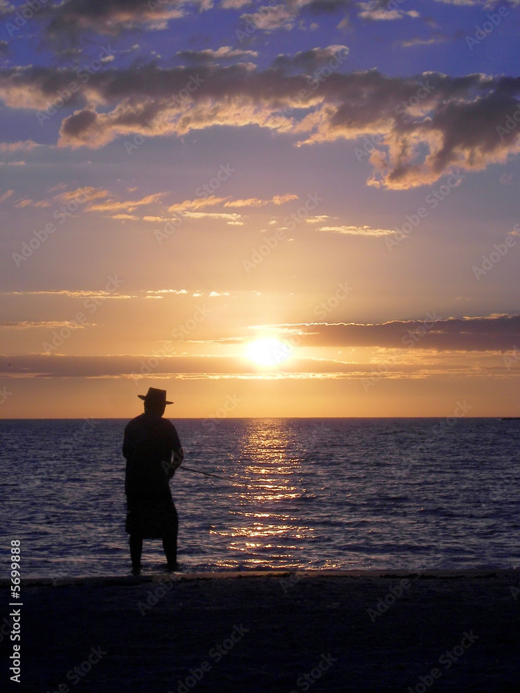 old man fishing at sunset