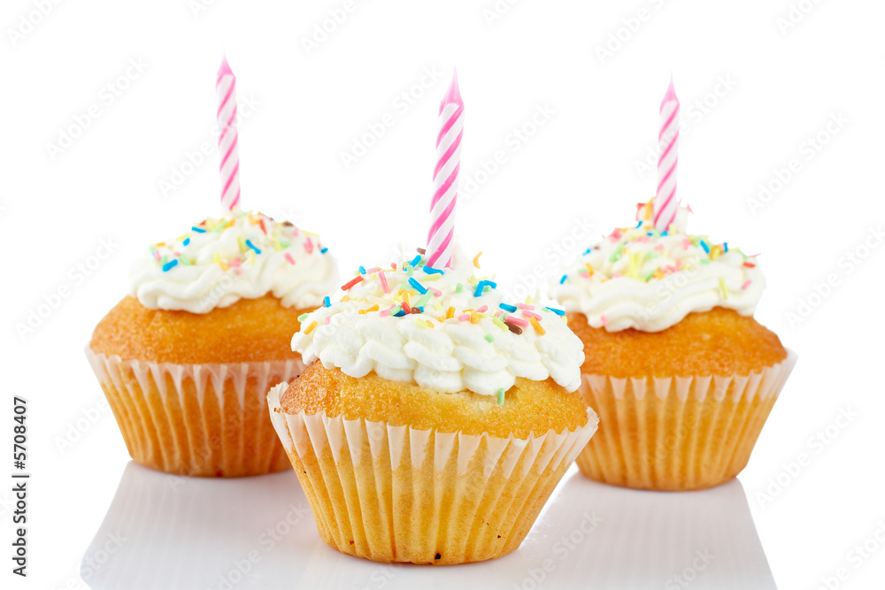 Muffins with candle reflected on white background. Shallow DOF Muffins with candle reflected on white background. Shallow DOF