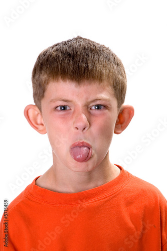 Young boy sticking out his tongue on a white background