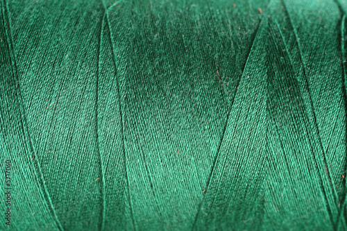 navey green thread fabric wool yarn wrapped in a spool photo