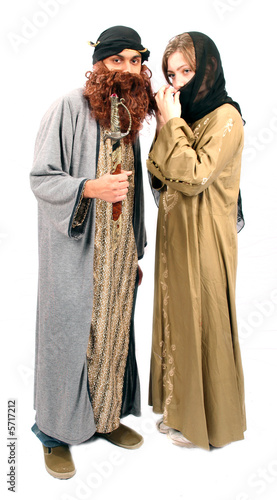 Arabic Arab veiled woman with Bedouin husband and sword