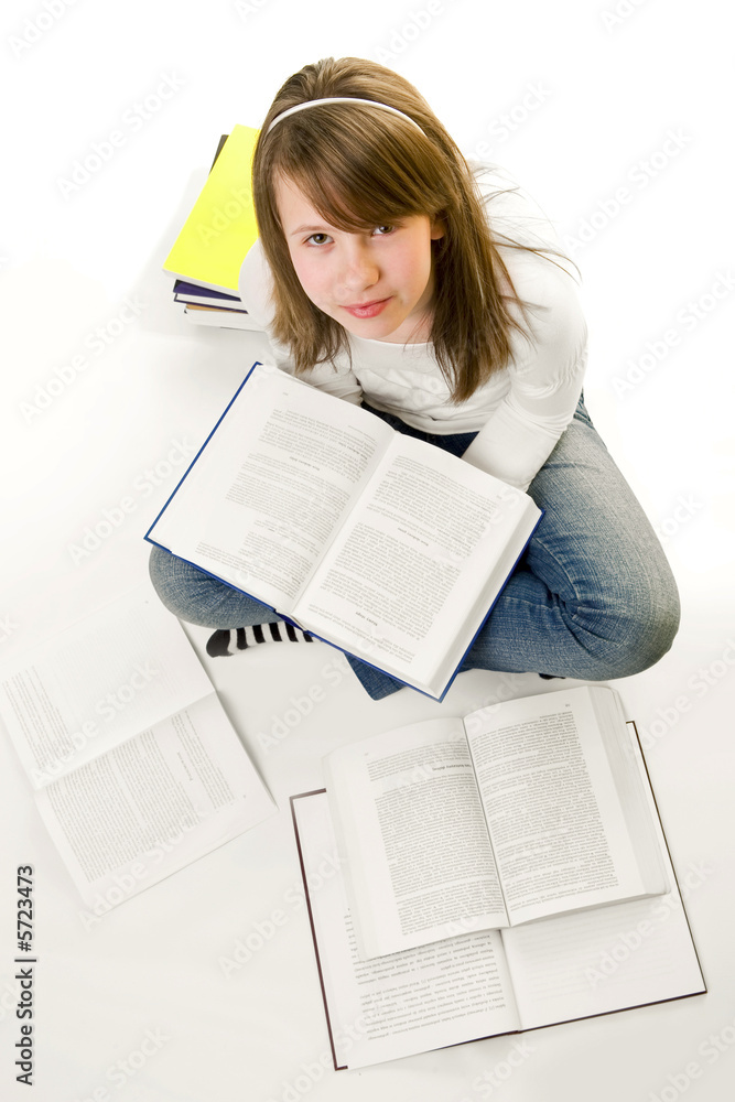 Obraz premium Portrait of Happy young schoolgirl reading books