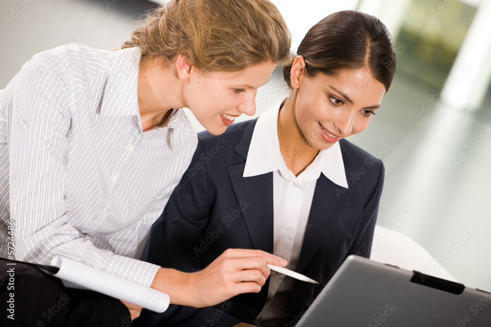 Portrait of two smiling business women working together Portrait of two smiling business women working together
