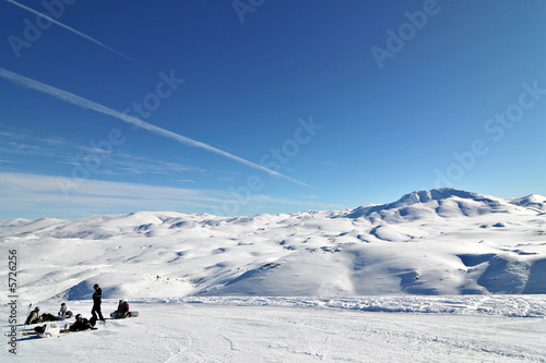 group of snowboarders in winter ski resort blue sky