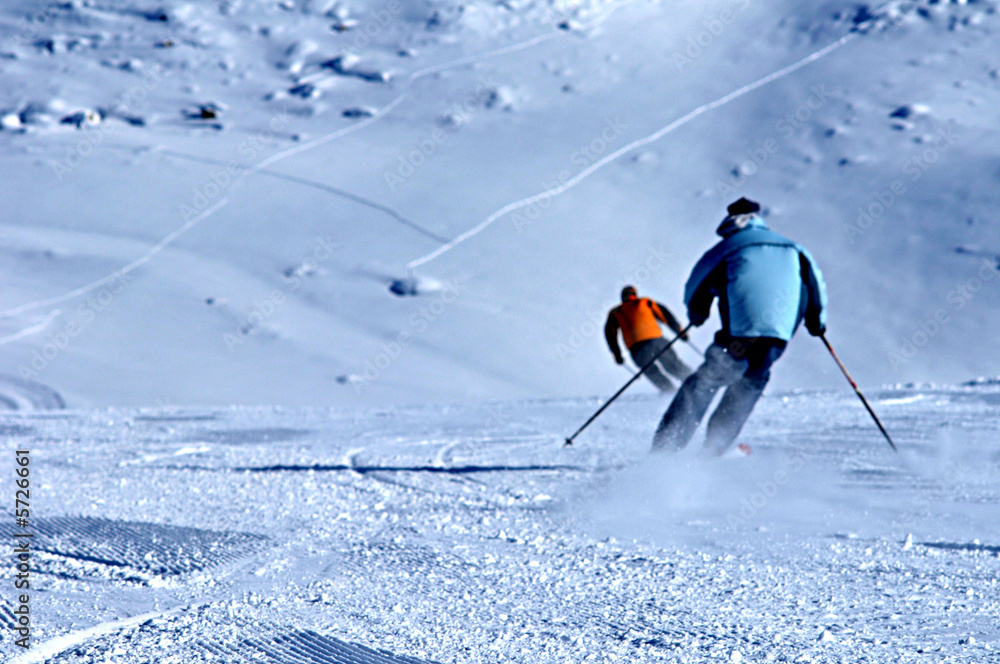 two skiers in winter ski resort