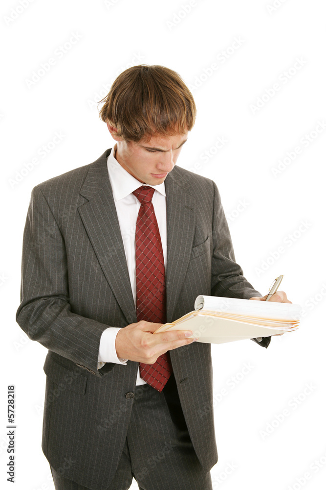 Handsome young businessman working out a problem Handsome young businessman working out a problem