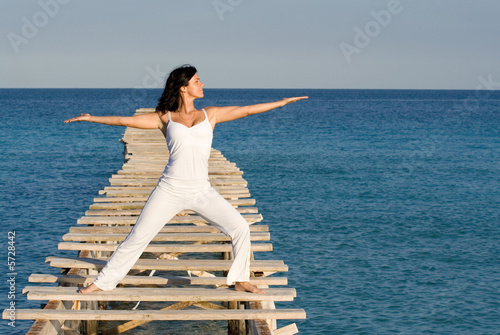 woman doing yoga or tai chi outdooors