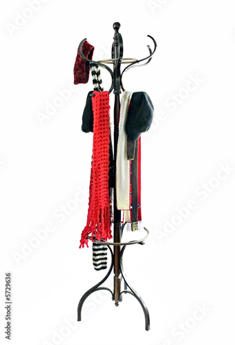 Vintage coat rack with winter hats and scarves.  