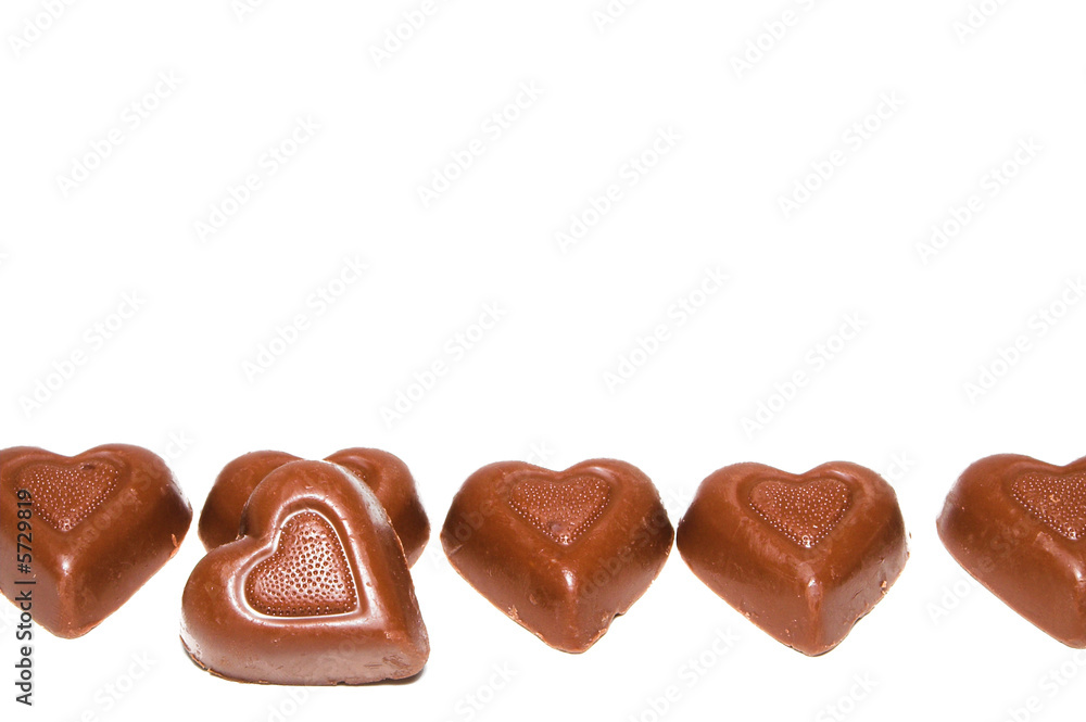 A line of delicious heart shaped milk chocolates. A line of delicious heart shaped milk chocolates.