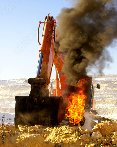 The dredge heats a ladle above a burning tire cover