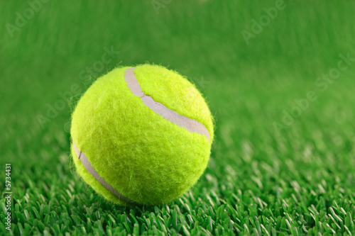 Tennis ball against grass background