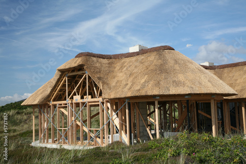 construction of half timberedhouse   with. thatched  roof photo