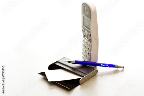 Cuadro en lienzo Pen laying on a case for cards and a telephone tube