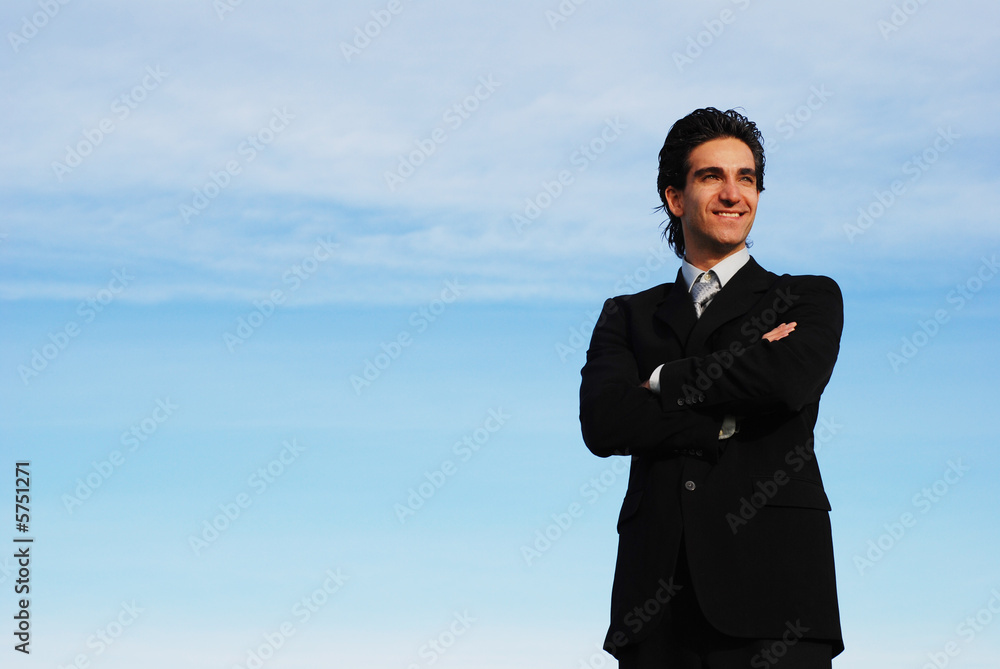 successful businessman is posing against the sky successful businessman is posing against the sky