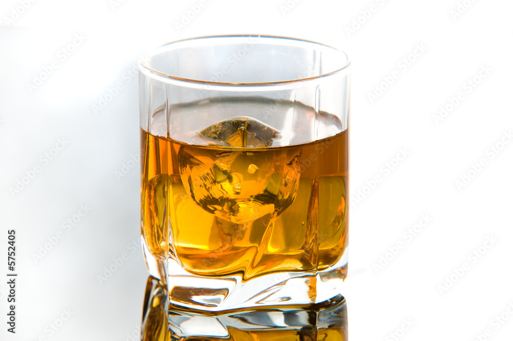 Whiskey in glass with ice cubes