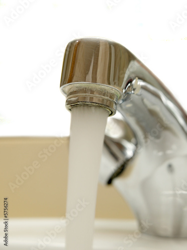 Close-up of head of mixer tap with water running