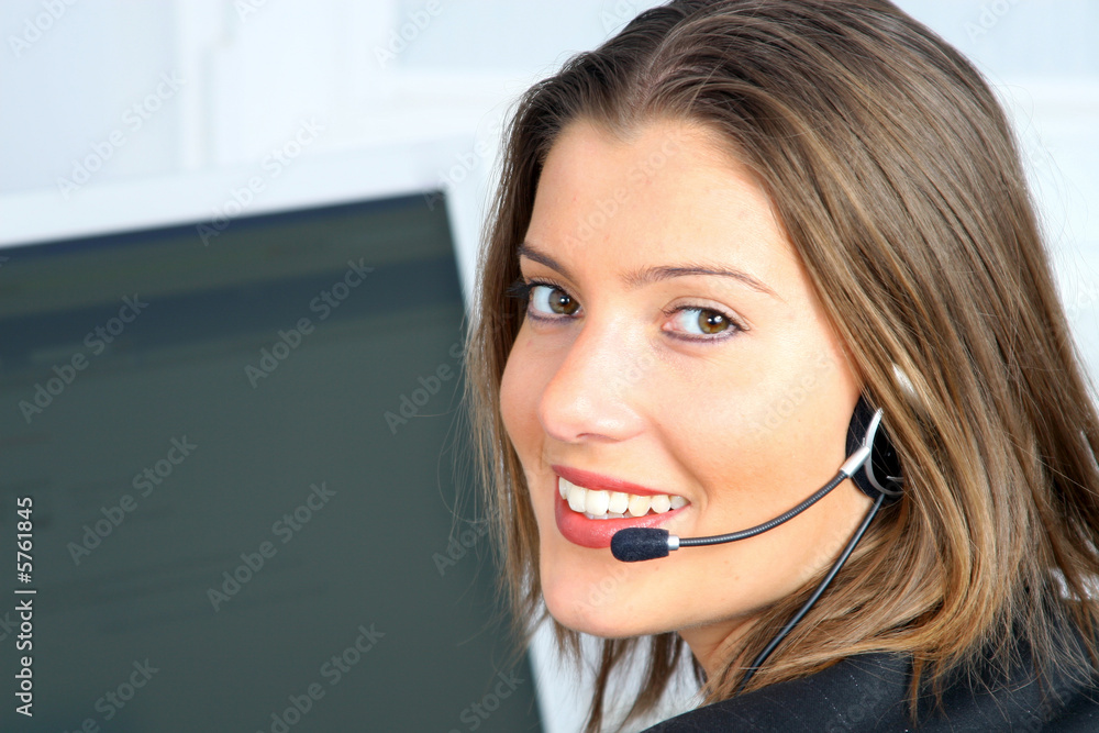 young woman on customer service with computer in background young woman on customer service with computer in background