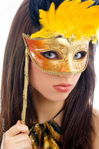 Beautiful woman weraing gold carnival mask..