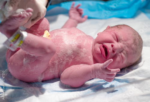 Newborn getting his first bath after birth