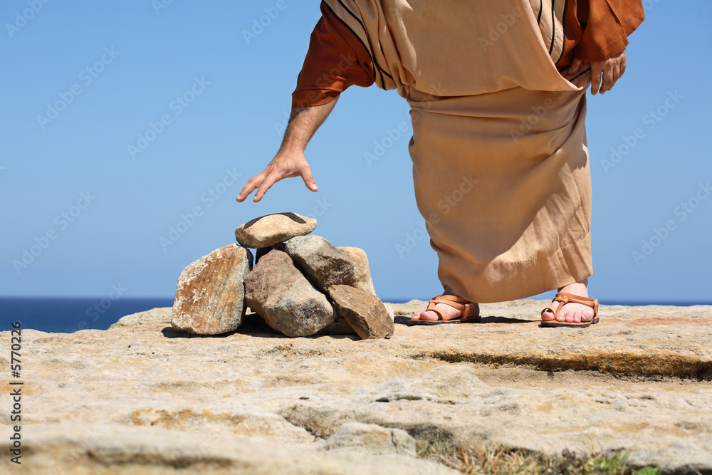 Man picking up stone. Concept - Sin, punishment Stock Photo