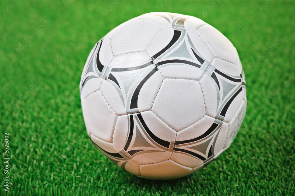 Fototapeta premium Soccer ball against grass background
