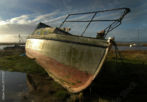 Cruser lying berthed at low tide