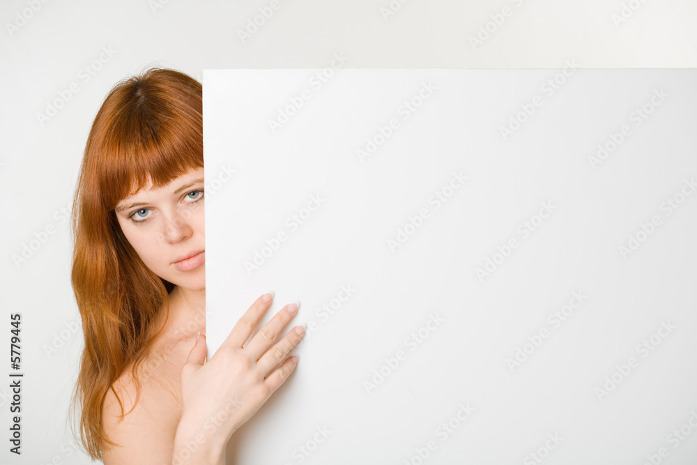An attractive redhead girl with empty sign An attractive redhead girl with empty sign