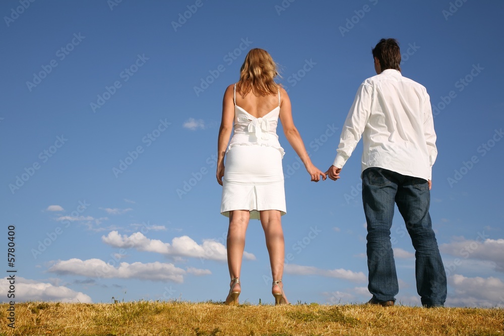 couple on meadow from back couple on meadow from back