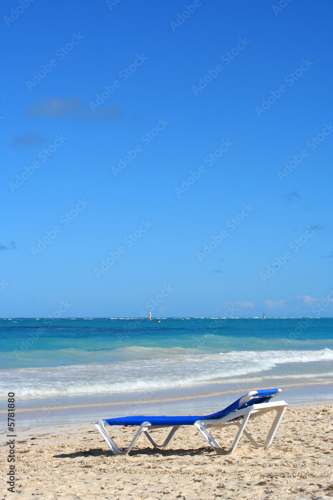 empty beach chair overlooking the ocean in Caribbean 