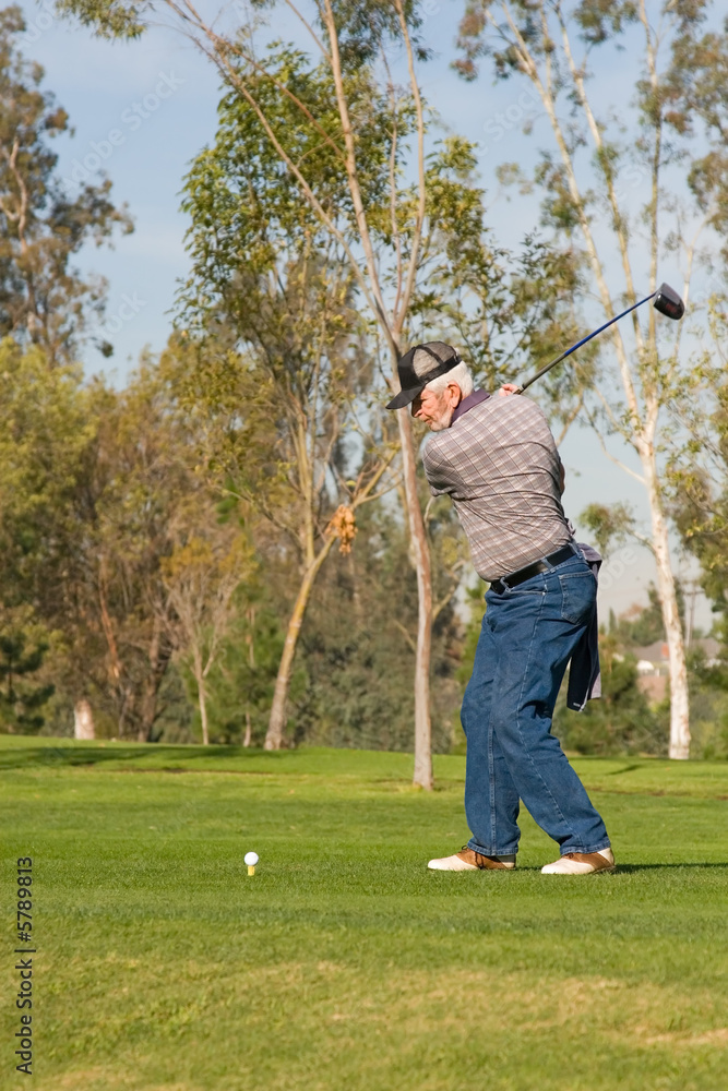 A golfer plays a round of golf at the country club resort