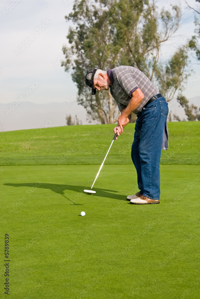 Fototapeta premium A golfer plays a round of golf at the country club resort