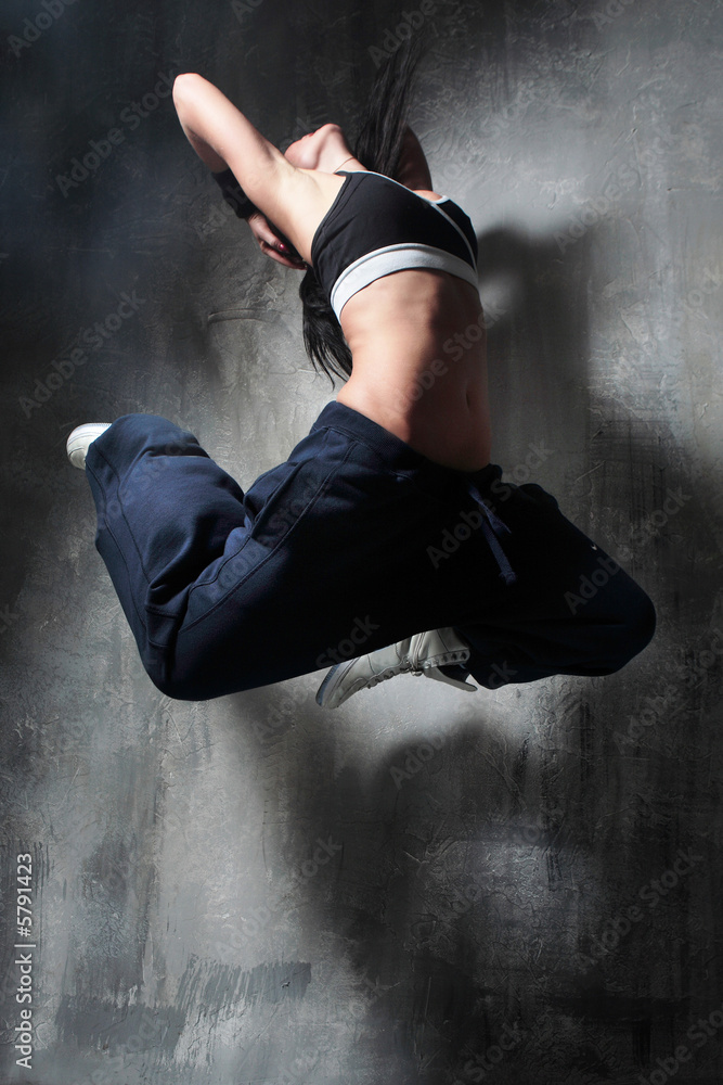 the dancer posing on dark grey background