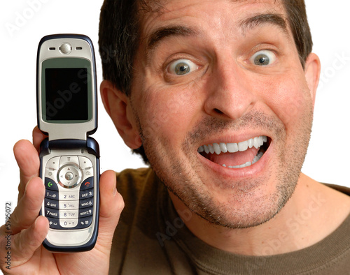 Smiling man holding up a cell phone.