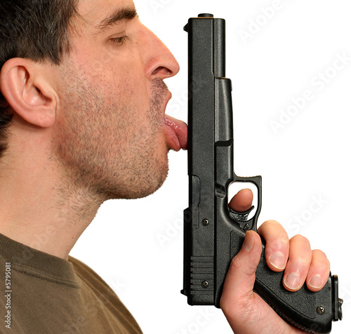 Isolated shot of a man licking a gun.
