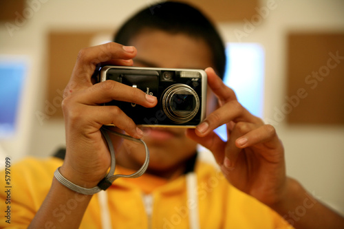 Young man taking pictures with a digital camera