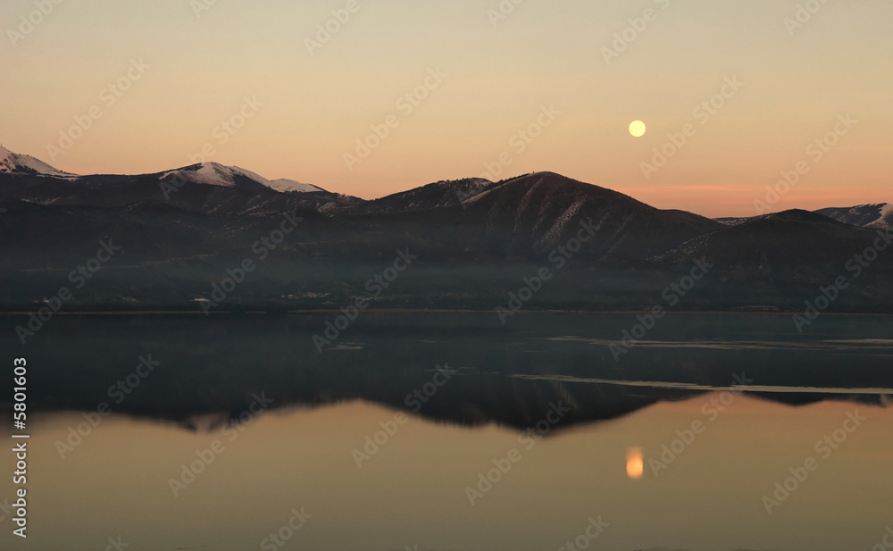 Moon rise over the mountain and lake waters