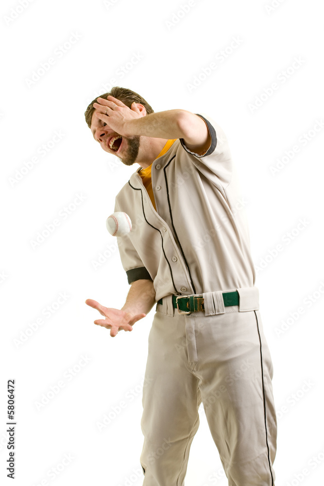 A young male baseball player hit by a ball A young male baseball player hit by a ball