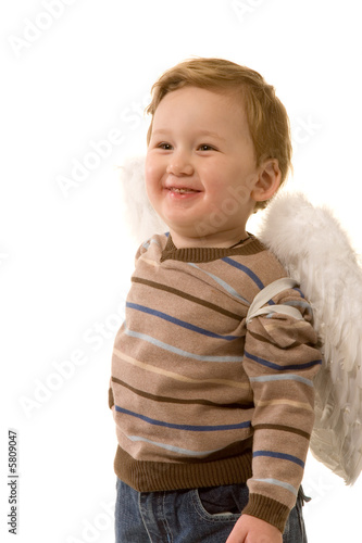 small merry boy dreessed as angel on white background