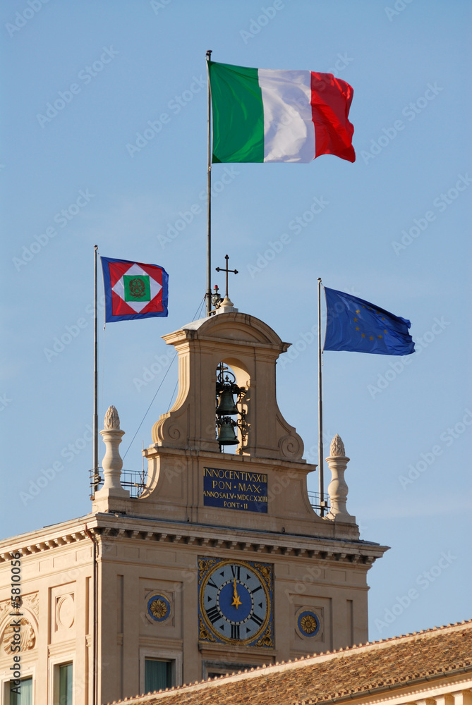 italian flag blowing in the wind on the palazzo del quirinale