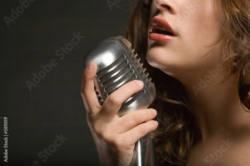 Beautiful sexy young woman singing