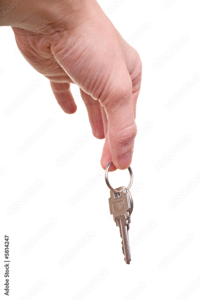 male hand holding house key isolated on white male hand holding house key isolated on white