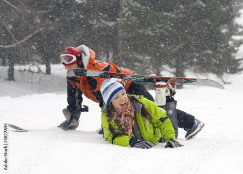 A lifestyle image of two young adult (age 18-20) snowboarders