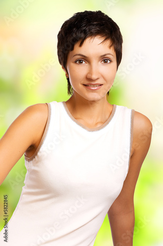 Smiling fitness woman. Isolated over green background.