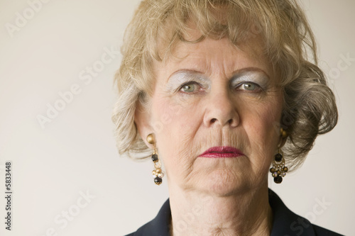 Close-up of a senior woman looking directly at the camera.