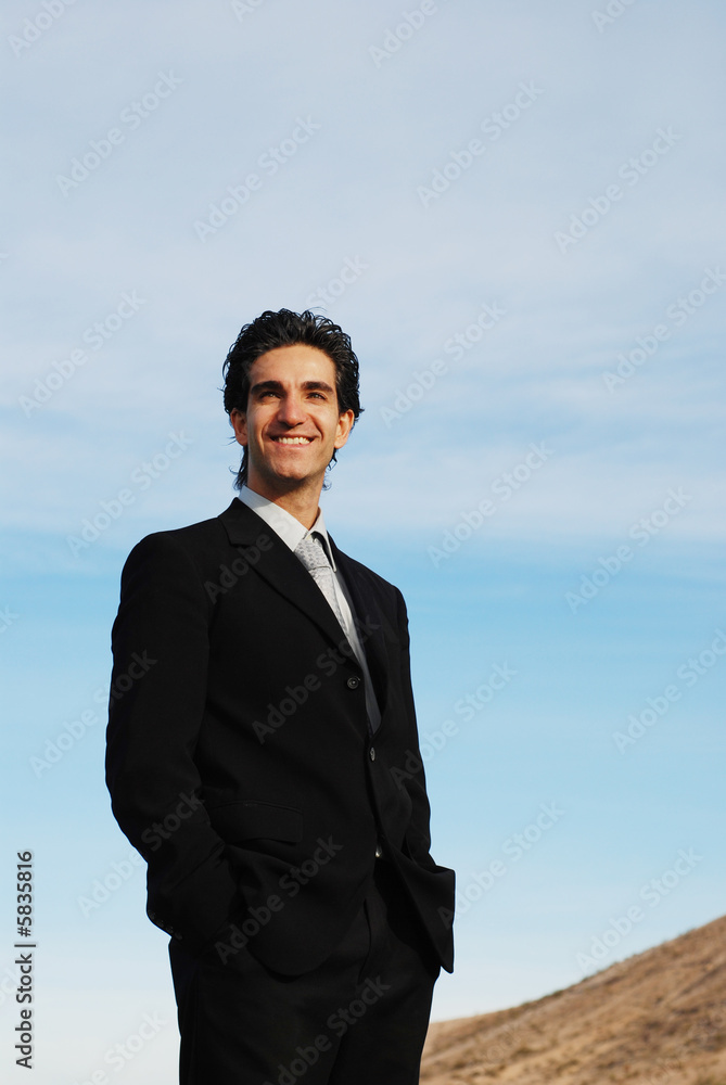 confident and successful businessman is posing against the sky confident and successful businessman is posing against the sky