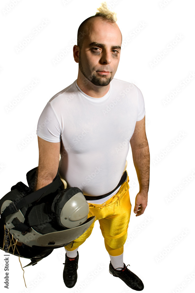 An American football player. Standing holding shoulderpads. An American football player. Standing holding shoulderpads.